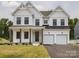 Stunning two-story home with a two-car garage, covered porch, and stylish curb appeal at 236 Paradise Dr, Belmont, NC 28012