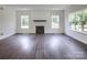 Open-concept living room features wood floors, a modern fireplace, and abundant natural light from large windows at 236 Paradise Dr, Belmont, NC 28012