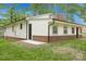 Rear exterior with brick foundation, white siding, and chimney at 240 Swink Ave, Salisbury, NC 28147