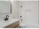 This renovated bathroom has a subway tile shower, a new vanity, and modern fixtures at 240 Swink Ave, Salisbury, NC 28147