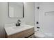 The renovated bathroom has a new vanity, modern fixtures, and a subway tile shower at 240 Swink Ave, Salisbury, NC 28147