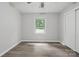 This bedroom includes luxury vinyl plank flooring, a double-door closet, and a window at 240 Swink Ave, Salisbury, NC 28147