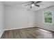 This bedroom has luxury vinyl plank flooring, a ceiling fan, and a bright window at 240 Swink Ave, Salisbury, NC 28147