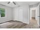 A spacious bedroom features luxury vinyl plank flooring, a window, and a double-door closet at 240 Swink Ave, Salisbury, NC 28147