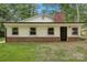 Rear view of home's exterior with brick foundation and white siding at 240 Swink Ave, Salisbury, NC 28147