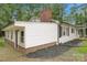 A charming home featuring white siding, black shutters, and well-maintained landscaping at 240 Swink Ave, Salisbury, NC 28147