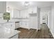Well-lit kitchen with stainless steel dishwasher and view through doorway at 240 Swink Ave, Salisbury, NC 28147