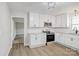 Modern kitchen with white cabinetry, stainless steel appliances, and granite countertops at 240 Swink Ave, Salisbury, NC 28147