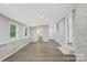 Bright living room features a modern paint scheme, brick accents, and wood-look floors at 240 Swink Ave, Salisbury, NC 28147