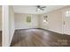 Bright living room with hard surface floors, neutral paint, ceiling fan, and large windows at 240 Swink Ave, Salisbury, NC 28147
