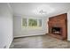Cozy living room featuring a brick fireplace and large windows overlooking the backyard at 240 Swink Ave, Salisbury, NC 28147