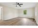 A spacious bedroom featuring a ceiling fan, hard surface floors, and neutral paint at 240 Swink Ave, Salisbury, NC 28147