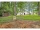 Property featuring white siding, brick foundation, chimney and detached garage at 240 Swink Ave, Salisbury, NC 28147