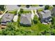Aerial view of home with large roof, manicured lawn, and mature trees providing privacy and shade at 2501 Christenbury Hall Nw Ct, Concord, NC 28027