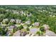 This aerial showcases a community with mature trees, sidewalks, green spaces, and a mix of architectural styles at 2501 Christenbury Hall Nw Ct, Concord, NC 28027