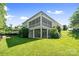 Spacious backyard featuring screened porch, patio area, and lush green lawn perfect for outdoor living at 2501 Christenbury Hall Nw Ct, Concord, NC 28027