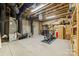Unfinished basement with furnace, exercise equipment, and shelving for storage at 2501 Christenbury Hall Nw Ct, Concord, NC 28027