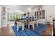 Bright dining room with a glass table, stylish chairs, and built-in display cabinet at 2501 Christenbury Hall Nw Ct, Concord, NC 28027