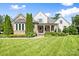 Beautiful home with a stone and stucco exterior, manicured lawn, and inviting front porch at 2501 Christenbury Hall Nw Ct, Concord, NC 28027