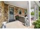 Inviting front porch with stone accents, comfortable seating, and charming decor at 2501 Christenbury Hall Nw Ct, Concord, NC 28027