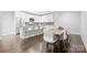 Open concept kitchen with stainless steel appliances, white cabinets, island, and adjacent dining area at 2501 Christenbury Hall Nw Ct, Concord, NC 28027