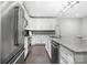 Bright kitchen with stainless steel appliances, white cabinetry, granite countertops, and hardwood flooring at 2501 Christenbury Hall Nw Ct, Concord, NC 28027