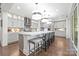 Modern kitchen featuring a spacious island with seating, stainless steel appliances, and custom cabinets at 2501 Christenbury Hall Nw Ct, Concord, NC 28027