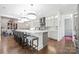Bright, modern kitchen with a center island and an open layout into the dining area at 2501 Christenbury Hall Nw Ct, Concord, NC 28027