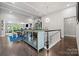 Open living space with hardwood floors, modern lighting, and staircase at 2501 Christenbury Hall Nw Ct, Concord, NC 28027