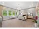 Serene main bedroom with a luxurious bed, stylish chandelier, and ample natural light at 2501 Christenbury Hall Nw Ct, Concord, NC 28027
