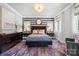 Luxurious main bedroom featuring striped accent wall, elegant furnishings, and ample natural light at 2501 Christenbury Hall Nw Ct, Concord, NC 28027