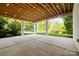 Covered patio with string lights providing an entertainment space overlooking a well-maintained lawn at 2501 Christenbury Hall Nw Ct, Concord, NC 28027