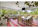 Screened-in porch features comfortable seating, dining space and views of the green, lush surroundings at 2501 Christenbury Hall Nw Ct, Concord, NC 28027