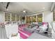 Stylish screened porch featuring a dining area, cozy seating, and modern decor with outdoor views at 2501 Christenbury Hall Nw Ct, Concord, NC 28027