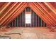Unfinished attic featuring exposed wooden beams and a window at 2504 Fallbrook Pl, Concord, NC 28027