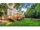 Charming backyard with a wooden deck and stairs, perfect for outdoor entertaining and relaxation at 2504 Fallbrook Pl, Concord, NC 28027