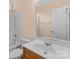 Bathroom with a shower-tub combination and a single-sink vanity with wood cabinets at 2504 Fallbrook Pl, Concord, NC 28027