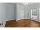 Bedroom with hardwood floors, large windows, and a double-door closet; lots of natural light at 2504 Fallbrook Pl, Concord, NC 28027