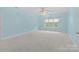 Carpeted bedroom with a ceiling fan and a window providing natural light at 2504 Fallbrook Pl, Concord, NC 28027