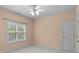 Neutral-colored bedroom featuring carpeted floors, a ceiling fan, and a window with blinds at 2504 Fallbrook Pl, Concord, NC 28027