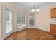Cozy dining area filled with natural light, featuring wood floors and an adjacent door to the outdoor at 2504 Fallbrook Pl, Concord, NC 28027