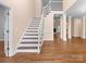 Welcoming foyer with hardwood floors and a staircase, offering a seamless flow into the adjacent living spaces at 2504 Fallbrook Pl, Concord, NC 28027