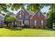 Charming red brick home with green shutters and a well-manicured lawn, showcasing curb appeal at 2504 Fallbrook Pl, Concord, NC 28027