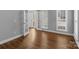Bright living space with hardwood floors, leading to a doorway and windows providing natural light at 2504 Fallbrook Pl, Concord, NC 28027