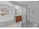 Elegant bathroom featuring a soaking tub, walk-in shower, and abundant natural light at 2504 Fallbrook Pl, Concord, NC 28027