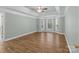 Large bedroom with a tray ceiling, hardwood floors, and bay windows offering lots of natural light at 2504 Fallbrook Pl, Concord, NC 28027