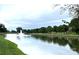 Scenic pond with a fountain, lush greenery, and reflections creating a peaceful atmosphere at 2504 Fallbrook Pl, Concord, NC 28027