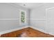 Bedroom with hardwood floors, window and a white door at 2519 2Nd Sw Ave, Hickory, NC 28602