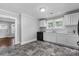 Well-lit kitchen features white cabinets, granite counters, black appliances and dark grey tile flooring at 2519 2Nd Sw Ave, Hickory, NC 28602