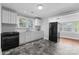 Well-lit kitchen features white cabinets, granite counters, black appliances and dark grey tile flooring at 2519 2Nd Sw Ave, Hickory, NC 28602